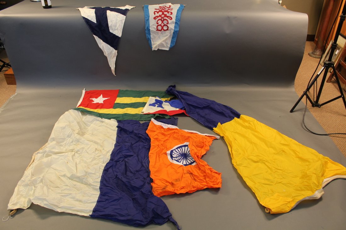 Box of Assorted Nautical Flags.: Box lot of mostly canvas nautical signal flags and burgees.