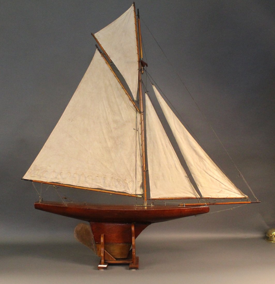 Vintage Pond Yacht Rigged with Sails: Vintage pond yacht rigged with a full suit of sails. Brass fittings include chain plates, tiller, mast base etc.. Hull has a lead keel. 53â€ x 8â€ x 58â€.