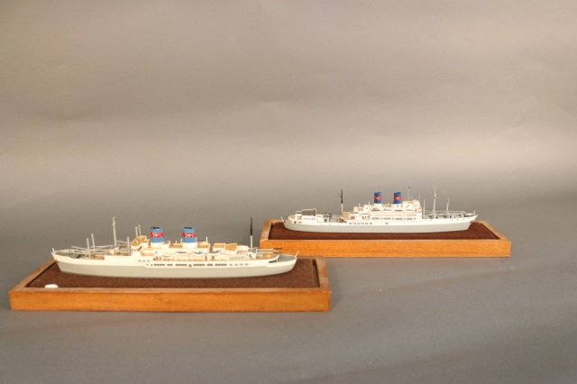 Pair of waterline cruise ship models: Pair of waterline cruise ship models with Christie's labels and maker's label of Tricee of Hong Kong. Case is 13" long.
