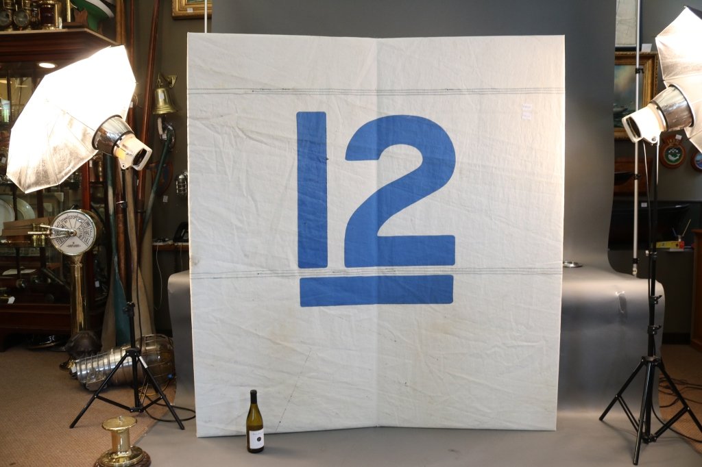 Sail Panel from America's Cup Yacht "Intrepid": Large section on sail cloth from the 1967 America's Cup defender "Intrepid." The large 12 for 12 meter is embroidered onto the sail. Sail cloth is fastened to two hinged doors. The size of area the 12