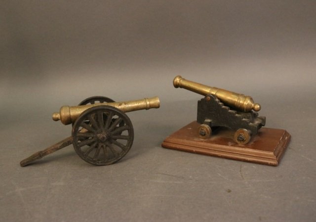 Two Decorative Cannons: Lot of one gatling gun and one cannon on carriage. Both old. Gun is 7.5" L Cannon on baseboard is 6"L Weight: 8lbs