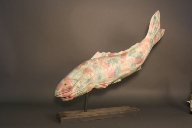 Fish Sculpture on Stand: Cast fish sculpture by Connecticut artist "Heuble" in tropical colors. Dimensions: 31" L x 6" W x 31" H Weight: 11lbs *This lot is part of a maritime antique auction of ship models, nautical relics, m