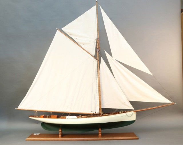 Large Model of the America's Cup "Puritan", 1885: Expertly crafted model of the America's Cup yacht "Puritan". Model is built with planked mahogany deck, skylights with brass bars, brass fittings, tiller, full suit of linen sails etc. No case. Model