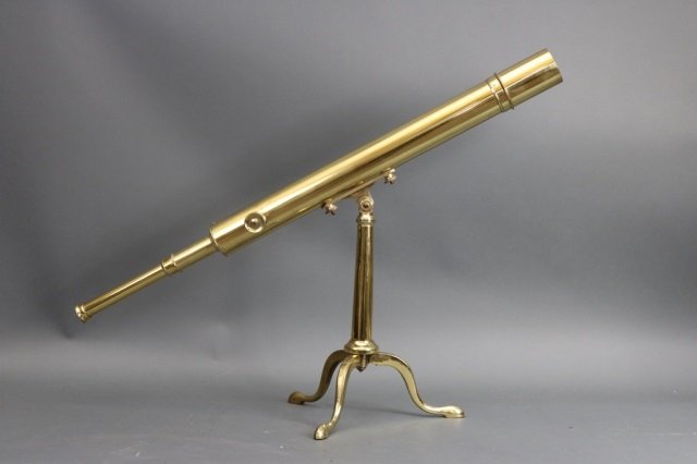 Table Top Library Telescope: Meticulously polished and lacquered telescope on a library tripod. Geared focal tube with knob. Dimensions: 41" L x 20" H Weight: 11lbs *This lot is part of a maritime antique auction of ship models,