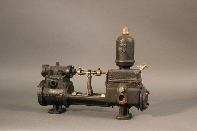 Bench Made Steam Engine: Bench made steam engine with brass fittings, relief valve, flanged feet and etc. Dimensions: 18" L x 8" W x 14" H Weight: 41lbs *This lot is part of a maritime antique auction of ship models, nautical