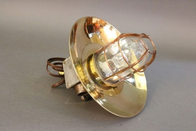 Brass Bulkhead Lantern: Brass bulkhead lantern with hood. Dimensions: 12" L x 10.5" W Weight: 8lbs *This lot is part of a maritime antique auction of ship models, nautical relics, marine paintings, boat parts, yachting colle