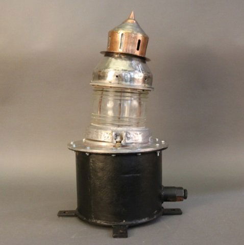 Pier Lantern on Base: Pier lantern on base with Fresnel lens. Dimensions: 25" H x 12" W Weight: 48lbs *This lot is part of a maritime antique auction of ship models, nautical relics, marine paintings, boat parts, yachting