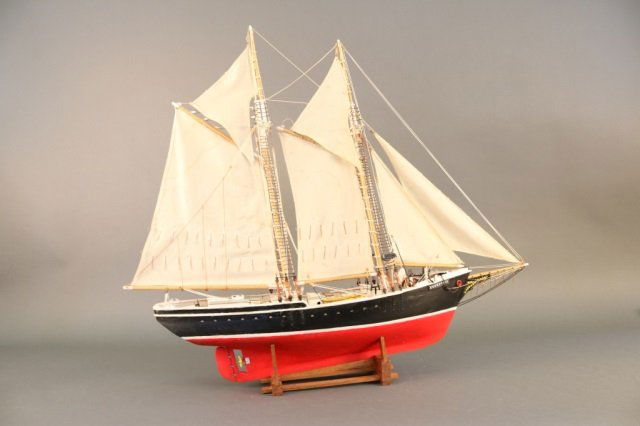 Model of the Fishing Schooner "Ernestina": Ship model of the American fishing schooner "Ernestina". Painted hull, cotton sails, cabins, dories, winch and etc. Mounted to a cradle. Dimensions: 34" L x 8" W x 30" H Weight: 3lbs *This lot is part