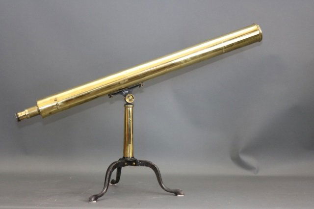 Brass Table Top Telescope: Solid brass ship's spyglass on brass and iron tripod. With geared focal tube. Dimensions: 40" L x 20" H Weight: 11lbs *This lot is part of a maritime antique auction of ship models, nautical relics, m