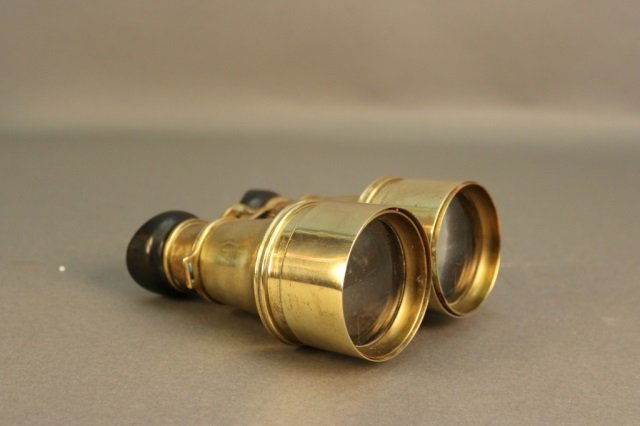 Pair of Brass Yachting Binoculars: Pair of antique brass yachting binoculars with focal tube. Dimensions: 6" L Weight: 5lbs *This lot is part of a maritime antique auction of ship models, nautical relics, marine paintings, boat parts,