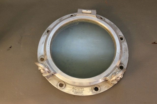 Aluminum Porthole: Aluminum porthole with two bolts. Dimensions: 17" x 5". Weight: 14lbs *This lot is part of a maritime antique auction of ship models, nautical relics, marine paintings, boat parts, yachting collectibl