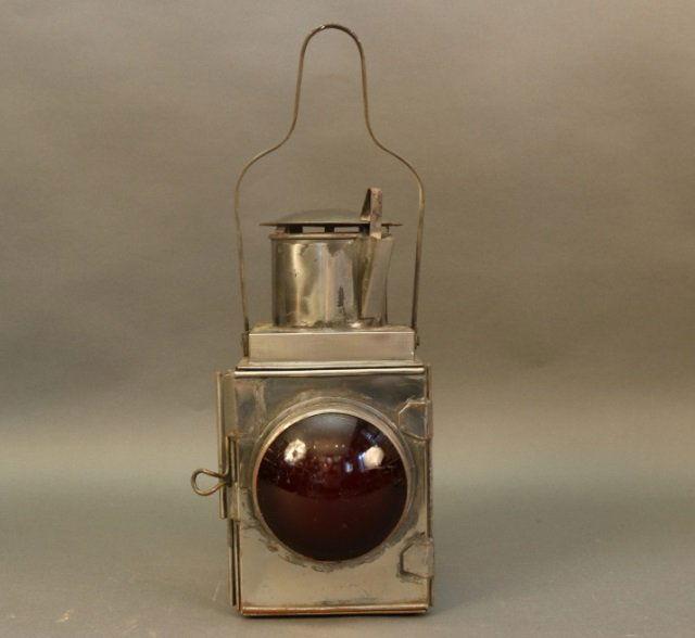 Steel Railroad Signal Lamp: Czechoslovakian railroad signal lantern with red lens, carry handle, vented top and etc. Dimensions: 8" L x 8" W x 14" H Weight: 8lbs' *This lot is part of a maritime antique auction of ship models, n