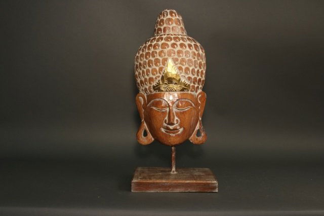 Carved Wood Buddha Head: Carved Buddha head with varnished finish. Dimensions: 12" L x 8.5" W x 26" H Weight: 4lbs *This lot is part of a maritime antique auction of ship models, nautical relics, marine paintings, boat parts,