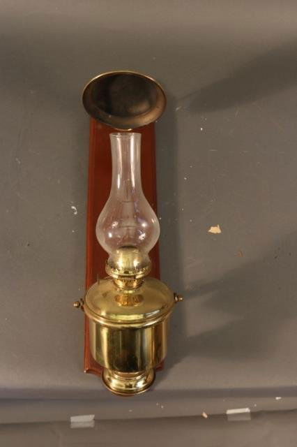 Gimballed Cabin Lantern: Solid brass gimballed yacht lantern with mahogany backboard and glass chimney. *This lot is part of a maritime antique auction of ship models, nautical relics, marine paintings, boat parts, yachting c