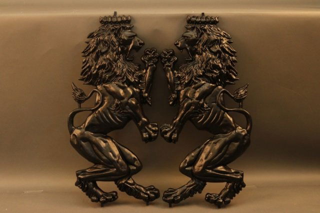 Pair of Metal Lions: Two painted lions meant for a wall or gates. Well detailed. Painted black. Dimensions: 15" L x 29" H Weight: 15lbs (pair) *This lot is part of a maritime antique auction of ship models, nautical relic