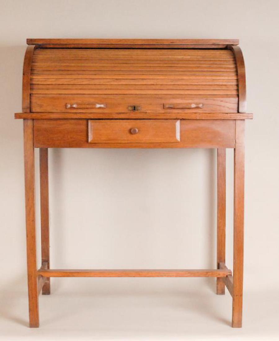 Diminutive Oak Rolltop Desk: Tambour roll opens to interior with cubbyholes and two drawers, single drawer below writing surface, stretcher base, early 20th century; 32 1/2"W, 41 1/4"H; ink and other stains to surface (Ref. 83)