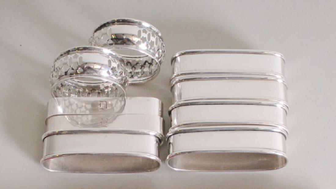 Assembled Set of Nine Sterling Napkin Rings: Including: Set of five elongated by Lunt, marked "Lunt Sterling 470", no monogram; 2 7/8" x 1", 5/8"W---Pair of elongated, marked "Randahl / Hand Wrought / Sterling / 15", each engraved with a differi