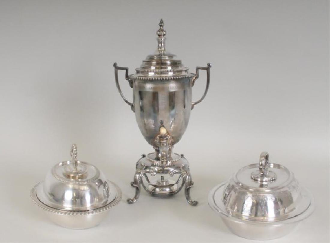 Silverplated Hot Water Urn, 2 Covered Vegetables: 1. Reed and Barton silverplated tea or hot water urn on base having four scrolled and acanthus decorated legs, trophy form with beaded and etched banding, etched vertical striping, blank cartouche on 