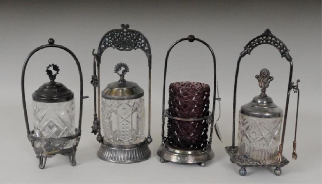 Four Pickle Castors in Stands: Amethyst daisy and button pickle castor, in a quadruple plate stand, Wilcox Silver Plate Co., marked "0661", 10"H; wear to plate on base of stand where glass jar rests---Three colorless pickle castors