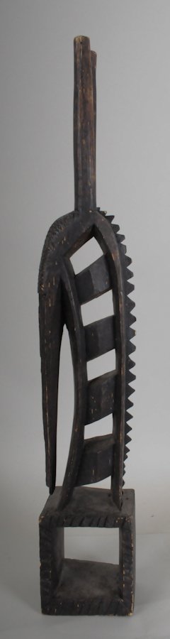 Bamana Chiwara Headdress: Stylized antelope with slender head and chip-carved ornamentation to forehead, tapering cylindrical horns, 20th century; 22 5/8"H, 2 7/8"W, 3 3/4"D---From the collection of a South Carolina gentleman