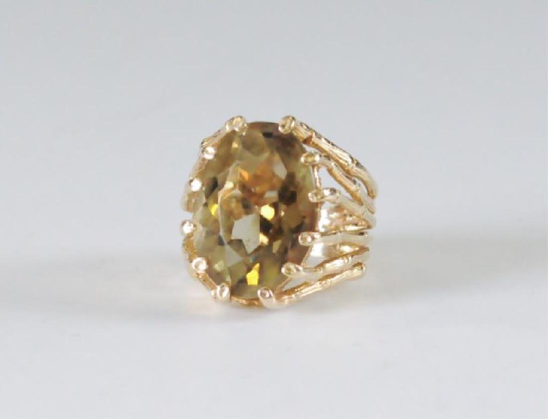 14k and Lemon Quartz Lady's Ring: Approximately 10-carat oval lemon quartz (18 x 12 1/2mm), set in a naturalistic mounting of 14k yellow gold, size 5 1/2, total weight 8.9 grams
