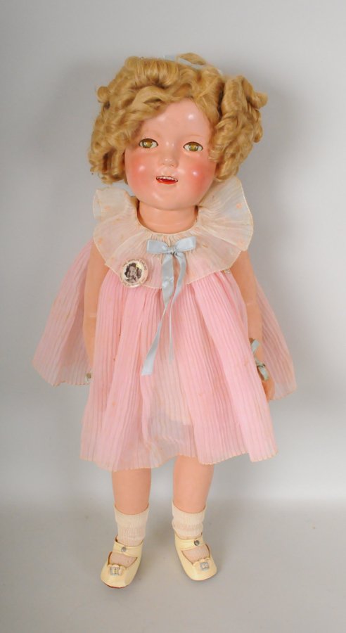 25" Original Ideal Shirley Temple Doll + Pitcher: Composition jointed body, honey blonde mohair wig, sleep eyes, painted and applied lashes, open mouth with teeth, dressed in tagged Shirley Temple pink pleated dress, one-piece cotton undergarment, iv