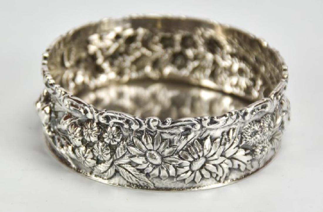 Jacobi & Jenkins Sterling Repousse Wine Coaster: Floral repousse; mark for Jacobi & Jenkins, 1894-1908; 3 5/8" dia., 1 1/4"H; good condition overall with small dents to base; total weight 3.160 ozt (Ref. 210-1)