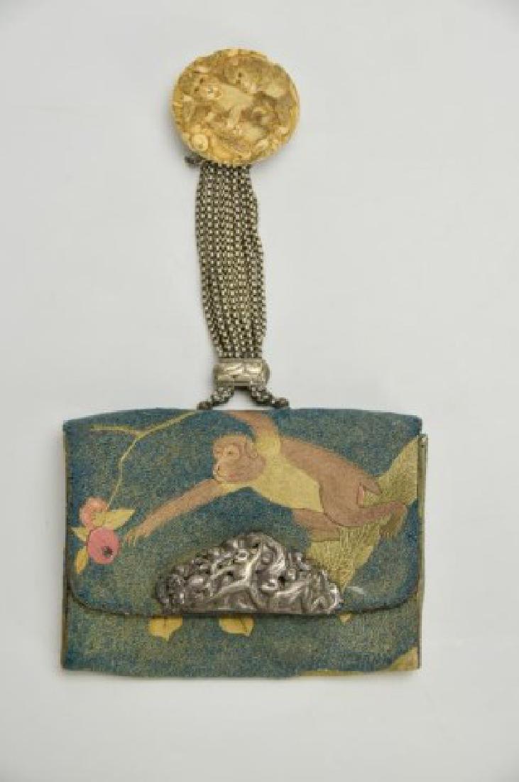 Signed Japanese Embroidered Tobacco Pouch: Late Edo / Meiji period, exterior with an embroidered monkey motif on an embroidered knot ground, clasp with a monkey motif in high relief on exterior and with a signed and engraved landscape scene on