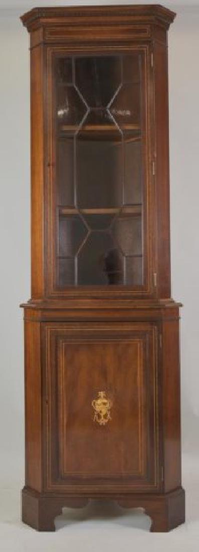 George III Style Inlaid Mahogany Corner Cabinet: One-piece construction, dentil molded cornice and inlaid frieze over a glazed door with mullions, interior with two shelves, lower section with paneled door having an urn inlay at center, interior wit