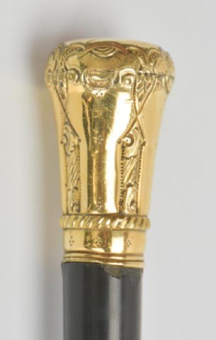 14kt Gold Gentleman's Walking Stick: Ornate gold knob stamped "14K", ebonized wood shaft, top of knob engraved "Dr. M. Harwood / Whately Mass."; 31 3/4"L; small chips to wood where gold knob meets shaft, dents to metal tip----In the pref