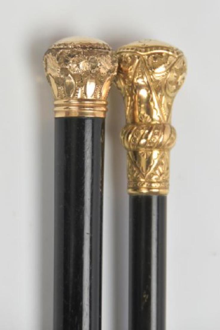 Two Gold Plated Walking Sticks: Each with ornate gold plated knob on ebonized wood shaft, one with monogram; 35 1/4"L and 34 3/4"L