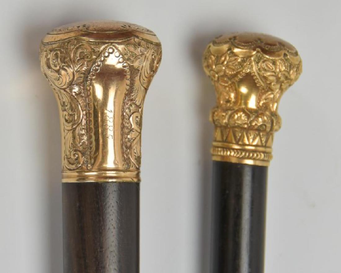 Two Gold Plated Walking Sticks: Each with ornate gold plated knob on ebonized wood shaft: 1. Top of knob engraved "Presented To / Eugene Hill / By His Friends / Aug. 5th, 1888", side of knob stamped "50A"; 35 1/4"L; minor abrasions 