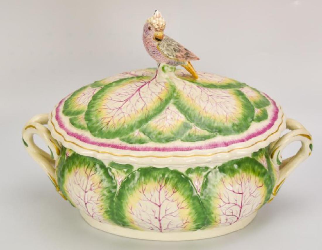 Mottahedeh Porcelain Covered Tureen: Decorated with cabbage leaves, openwork double handles, lid with exotic bird finial, base marked "Italy" and with paper label "A Mottahedeh design"; 13" x 7 3/4", 9 1/2"H; good condition
