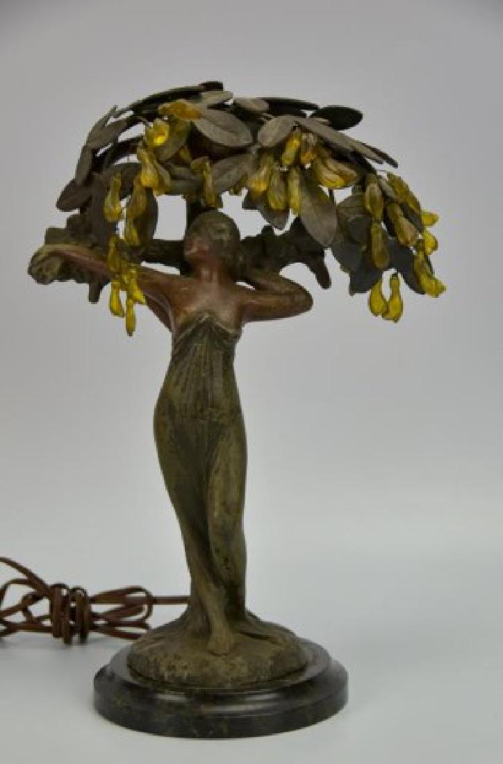 Art Nouveau Figural Lamp: Female figure leaning against a tree trunk under a canopy of leaves and glass fruit with a single light socket, patinated metal, mounted on marble base, early 20th century; 10 3/4"H; repaired chip to 