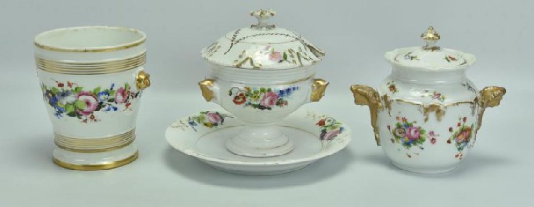 Grouping of Old Paris Porcelain: 1. Old Paris porcelain cache pot, reeded and gilt banding, lion's head handles, band of hand painted multicolored flowers encircle the pot, with separate saucer base, base marked with incised "L G"; 5