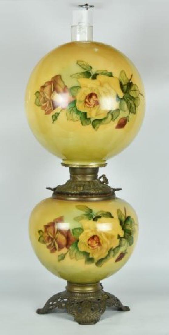 Gone with the Wind Lamp: Ball shade and font with matching rose decoration on a yellow and green ground, filler cap marked "Made in U.S. of America", openwork cast metal base, electrified; 26 1/2"H to top of chimney, approx.