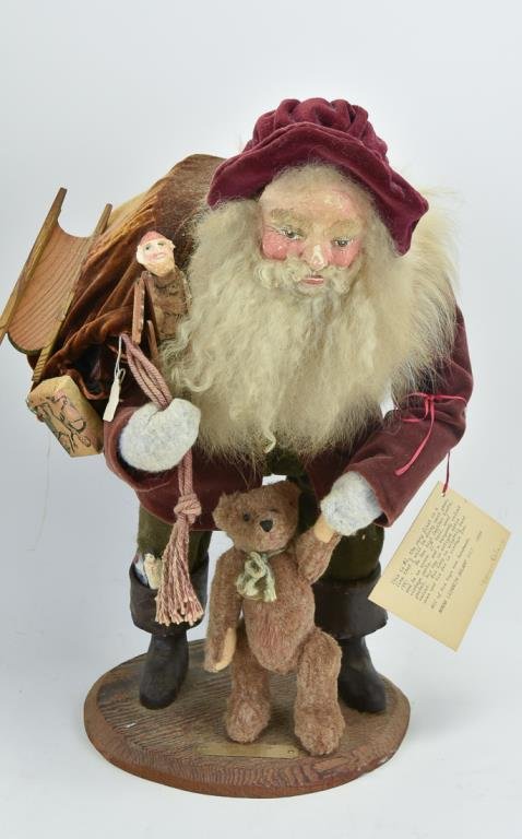 Norma Lizabeth DeCamp (North Carolina, 20th C.): Handcrafted original Santa by noted artist Norma Decamp; #1 prototype, papier mache Santa with a teddy bear dangling from one hand, his other hand holding the rope to the bag of toys on his back, reta