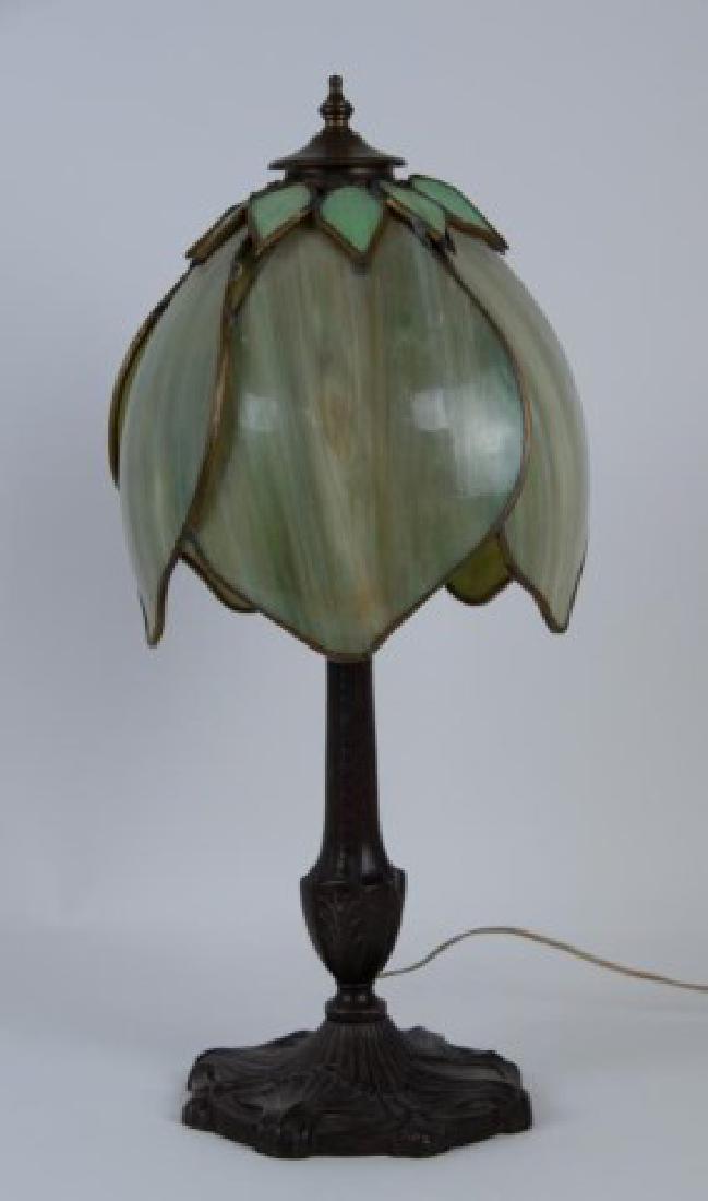 Pittsburgh Slag Glass Lamp: Green slag glass lamp shade comprised of five petal-form panels with ten small leaves encircling the top, metal base having a circular foot with shell motif and stem with acanthus decoration, marked "