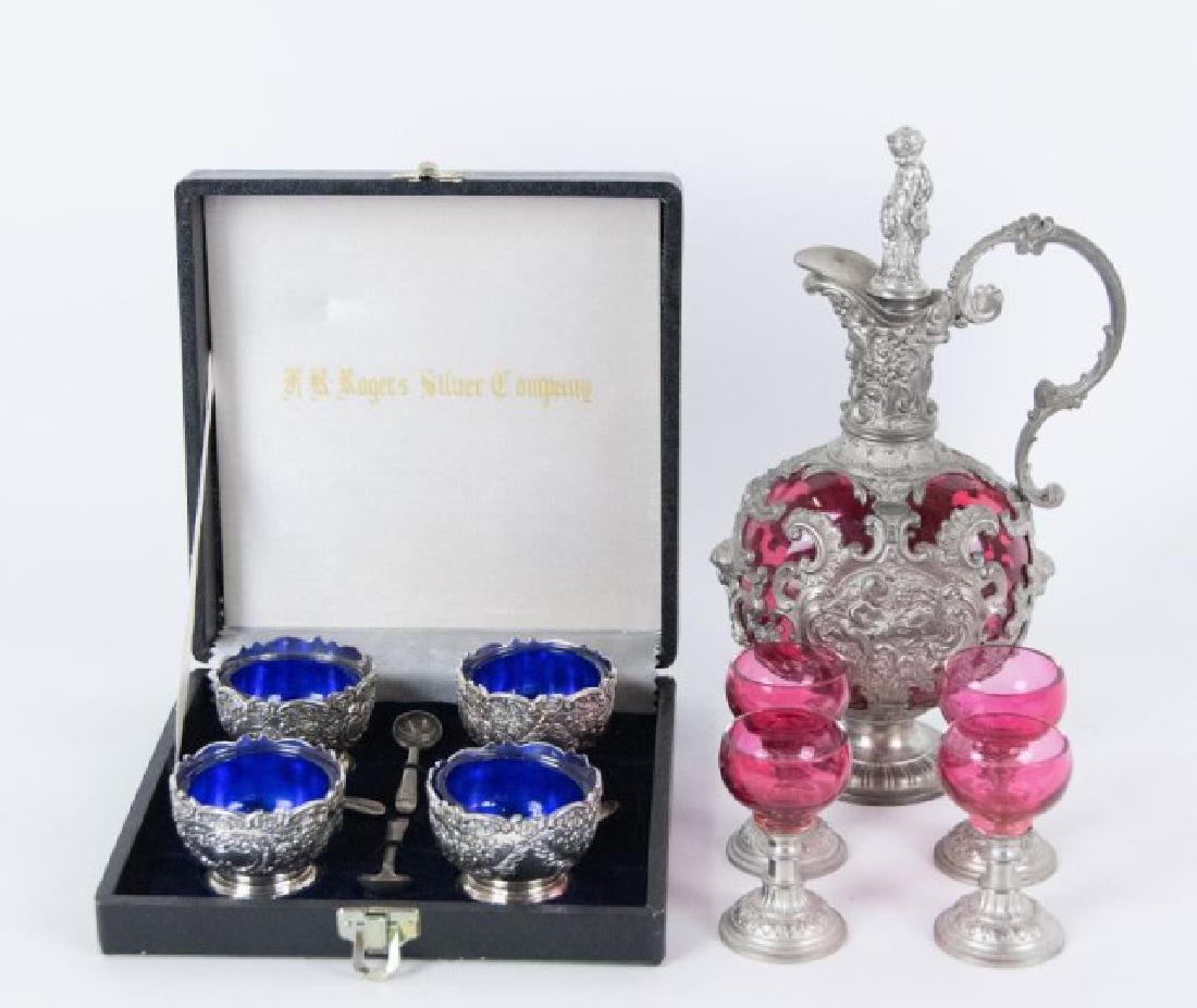 19th C. Cranberry Glass Ewer & Cordials + Cobalt: Lot includes a 19th century Continental pewter mounted cranberry glass decanter with four cordials and a set of four American silver plate open salts having cobalt glass liners: 1. Decanter comprised 