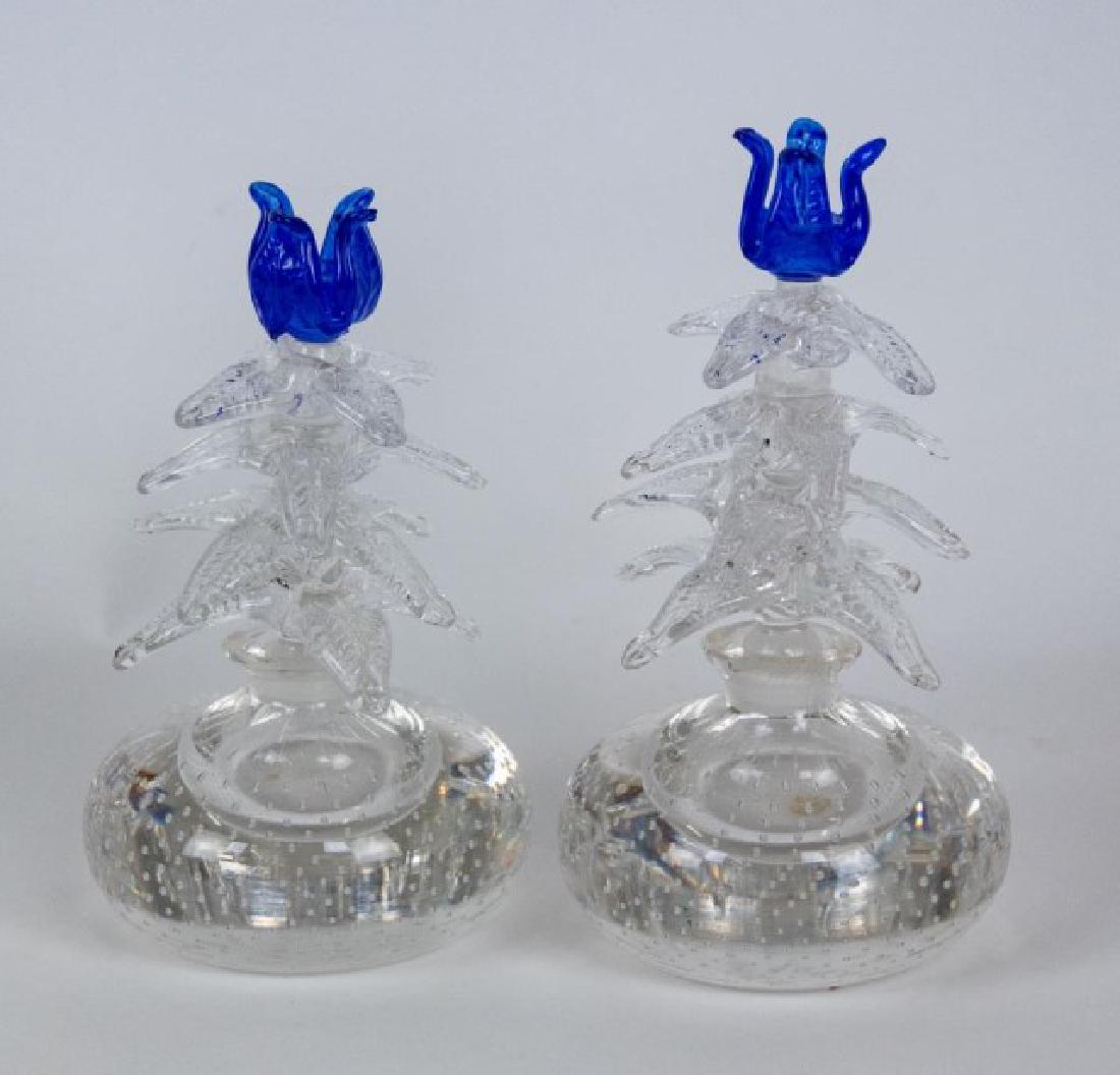 Pr. of Gunderson Pairpoint Perfume Bottles: Paperweight style base with controlled air bubble decoration, tall flower stem stopper comprised of four tiers with each tier having four textured leaves and surmounted by a cobalt flower blossom, att