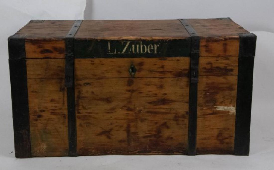 Early 19th C. Pine Travel Trunk: Pine trunk with wrought iron bands, corners, hinges and handles; rosehead nails; stenciled name to front "L. Zuber"; 38"W, 20"H, 19 1/4"D; supplemental hinges later addition