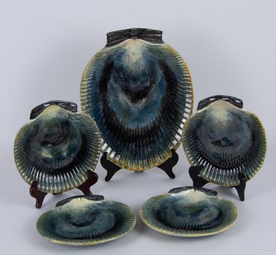 Majolica Shell Form Platter & Plates: Majolica shell form platter with set of four matching plates, each with illegible impressed marks to base; platter 10 3/4" x 13 1/2"; plates 8 1/8" x 8 1/4"; platter with a few small glaze chips aroun