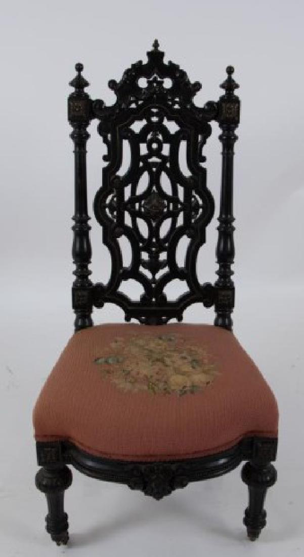 Gothic Revival Carved & Ebonized Hall Chair: 19th century, Gothic Revival carved and ebonized chair with applied brass rosettes, accents and beaded brass inlay; carved arched crest centered with brass flame finial above intricate pierced splat, 