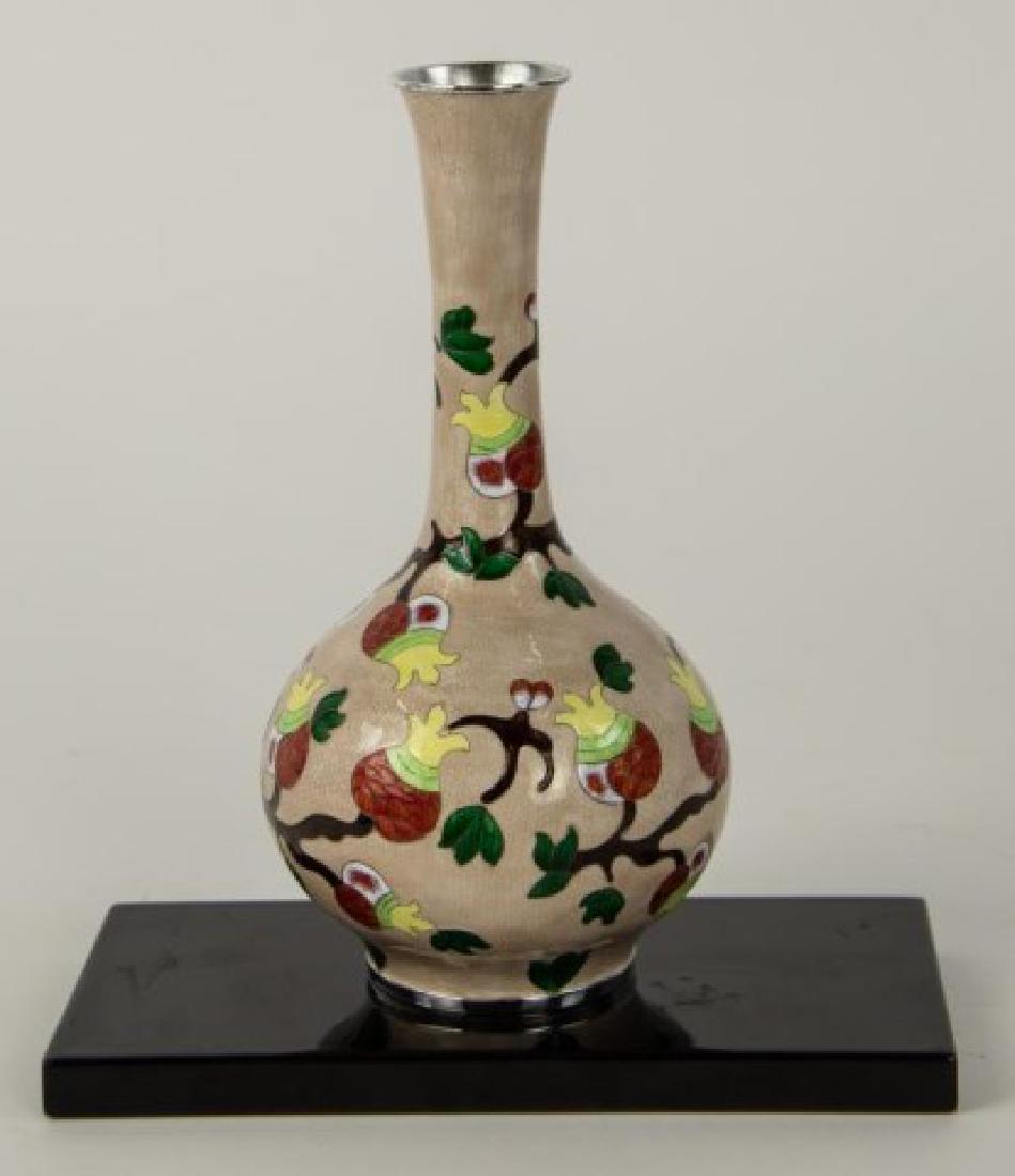 Signed Cloisonne & 99 Silver Vase: Bottle form enameled sterling silver vase; tan ground decorated with brown branches having green leaves and flowers in orange, lime green, yellow and white; base marked with unknown maker's mark and "