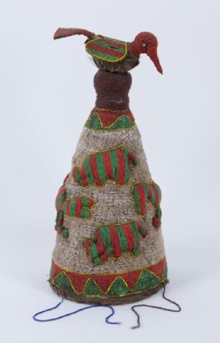 Yoruba Nigeria African Royal Beaded Headdress: Handmade conical ceremonial headdress crown covered with glass beads in red, green, yellow, tan and burgundy; sides having six green and red striped animal sculptures, bird finial on top, old cloth li