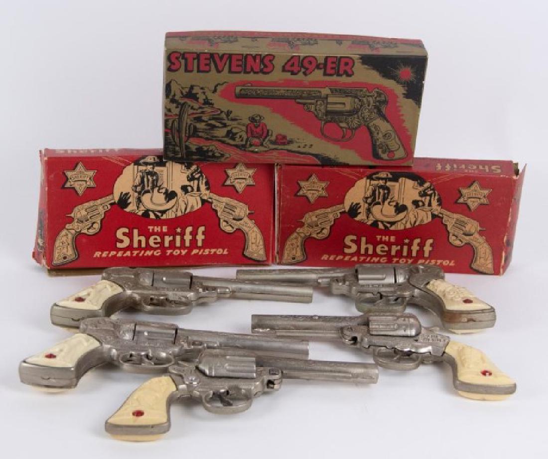 5 Stevens 49-ER & The Sheriff Toy Cap Guns: Three in original boxes, J. & E. Stevens Co.: 1. "Stevens 49-ER" cast iron cap gun, embossed pioneer wagon and cowboy on grips, marked "49-ER" on each side below cylinder, in original box; 9"L; very g