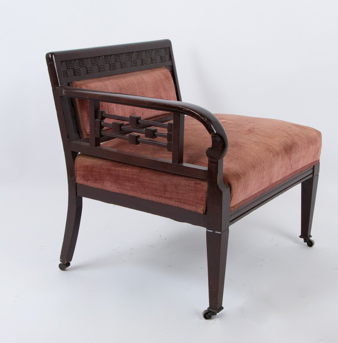 American Aesthetic Movement Slipper Chair: Fourth quarter 19th century, mahogany, crest with geometric carvings, single open arm with turnings and carved geometric accents, square tapered legs, on casters; 28"W, 25"D, 28"H, seat 16"H; upholste