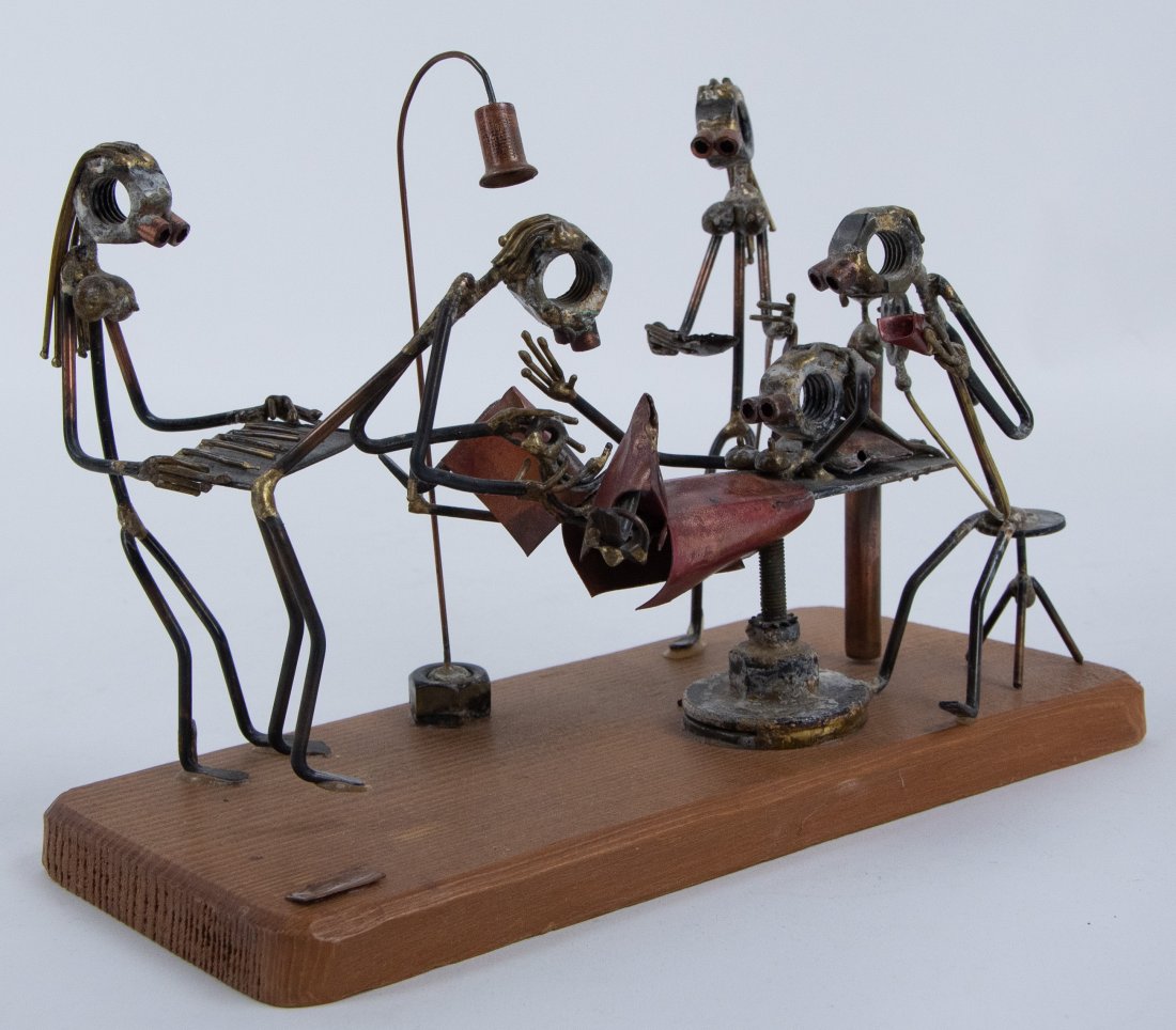 Nuts & Bolts Sculpture of Delivery Room: Contemporary figural sculpture composed of nuts, bolts, wires and other found metals; depicting a delivery room with mother on bed with feet in stirrups, male doctor standing at her feet deliverying b