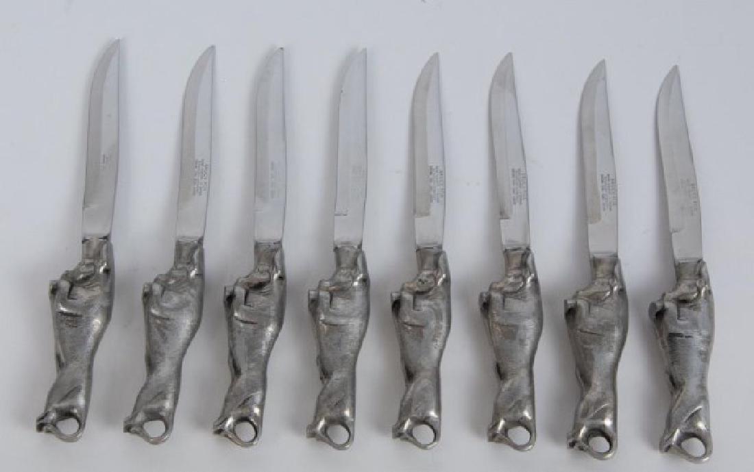 Set of 8 Bruce Fox Charging Bull Steak Knives: Handles in the form of a charging bull, blades marked "Bruce Fox / New Albany - Indiana / Solingen - Germany / Chrome Steel Hand Forged"; 8"L; one with bend to tip of blade (Ref. 19)