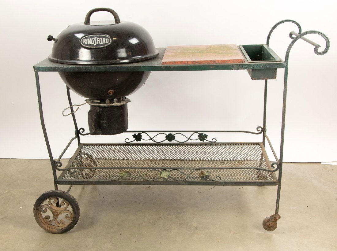 Metal Grilling Cart: Round Kingsford charcoal grill mounted in a metal rolling cart with granite 17 1/4" x 13" serving surface, lower shelf; overall 46"L, 22 1/2"W, 33 1/2"H; rubber missing on one wheel, scattered corrosi